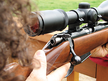 Merrilee Lewis sights on a rockchuck. The CZ 452 in 17 HMR proved a good option in rather built-up areas because the tiny bullet tended to blow apart on a rock rather than ricochet and go spanging off into a new subdivision.